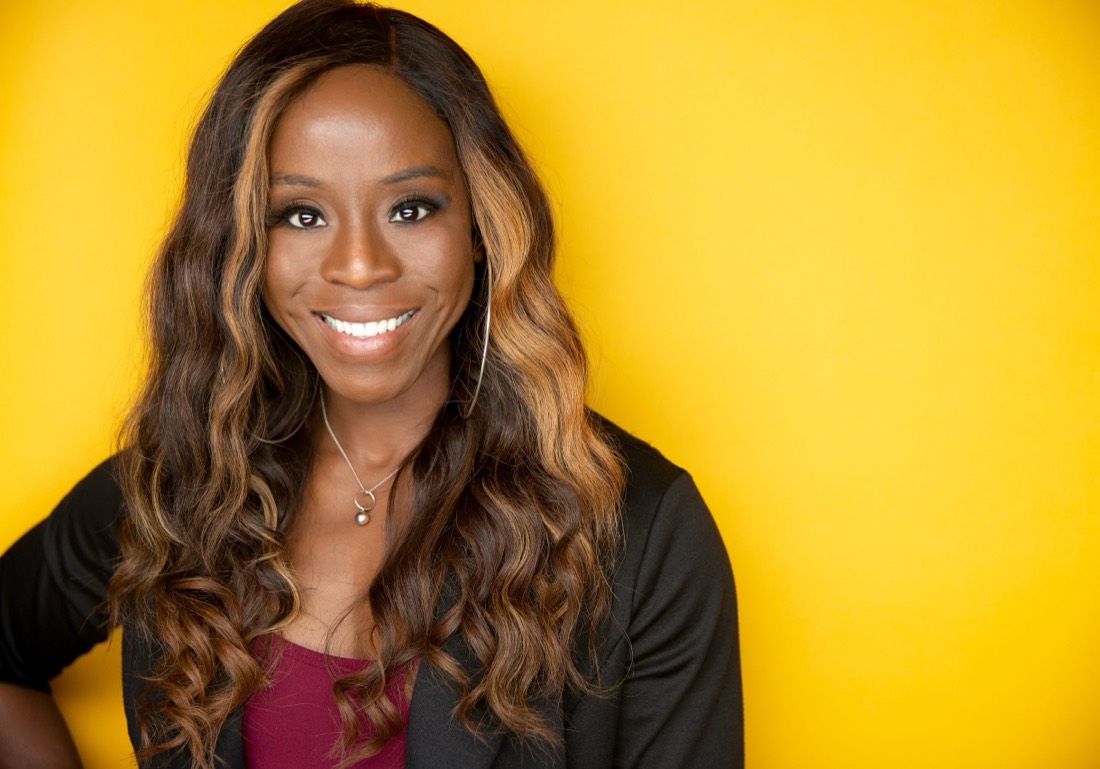 Ruth Unaegbu smiling in front of a yellow background